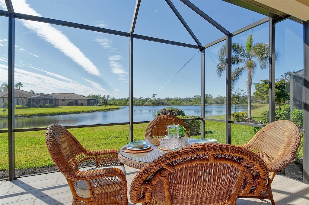 sunroom / solarium with a water view and a wealth of natural light