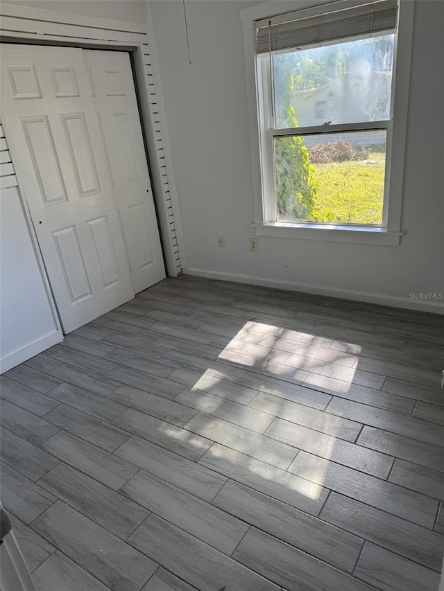 unfurnished bedroom featuring a closet and light hardwood / wood-style flooring