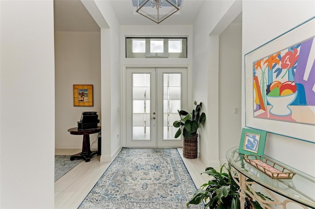 foyer with french doors and baseboards