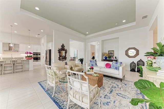 tiled living room featuring a tray ceiling