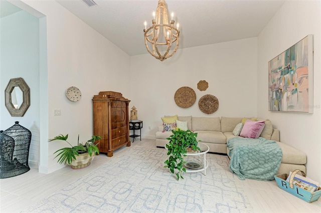 tiled living room with baseboards and a chandelier