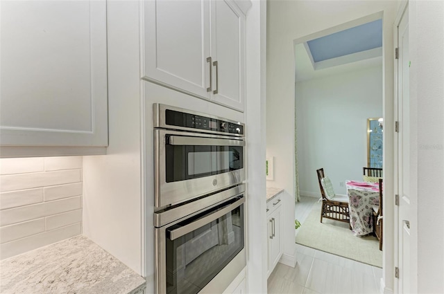 kitchen with white cabinetry and stainless steel double oven