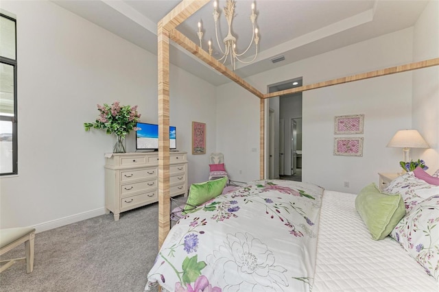 carpeted bedroom featuring a notable chandelier, visible vents, baseboards, and a tray ceiling