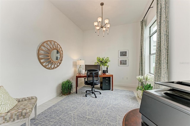 office area with baseboards and a notable chandelier