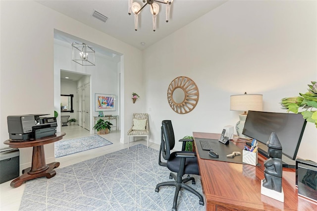 home office featuring hardwood / wood-style flooring, a chandelier, and a high ceiling