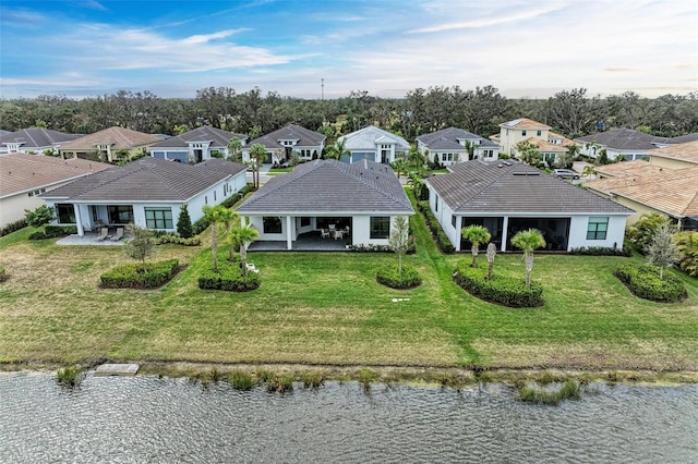 drone / aerial view with a residential view and a water view