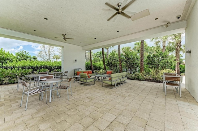 view of patio with ceiling fan, outdoor dining area, and an outdoor hangout area