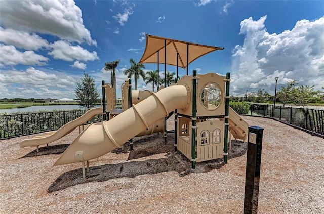 community jungle gym featuring a water view and fence