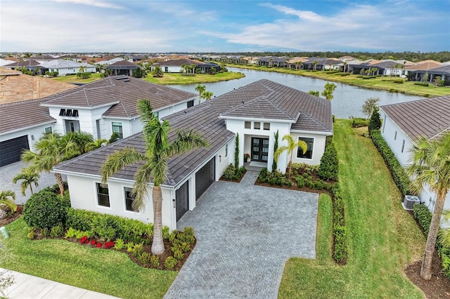 drone / aerial view featuring a residential view and a water view