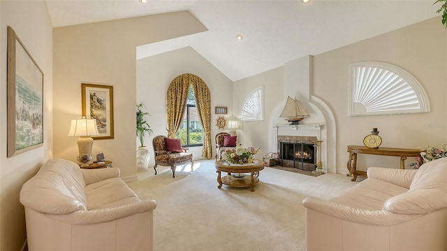 sitting room with vaulted ceiling, a fireplace with flush hearth, carpet flooring, and baseboards