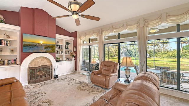 living area with vaulted ceiling, built in shelves, and a wealth of natural light