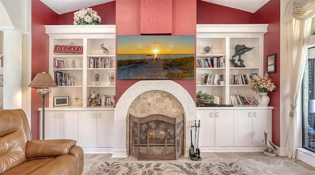 sitting room with a fireplace with flush hearth, built in features, and vaulted ceiling