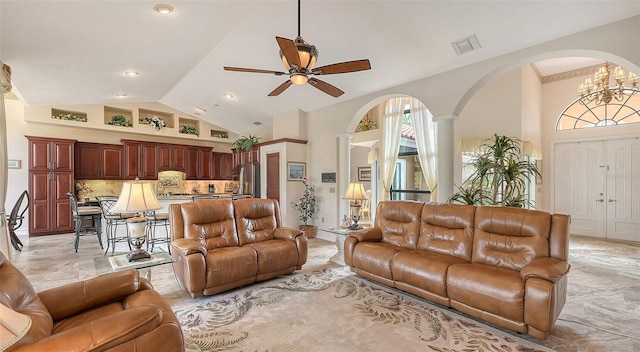 living area with high vaulted ceiling, visible vents, and ceiling fan with notable chandelier