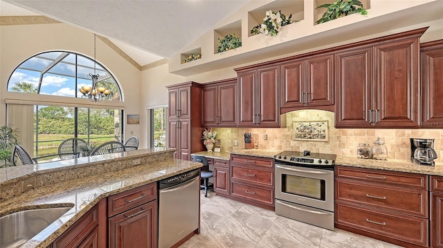 kitchen with appliances with stainless steel finishes, hanging light fixtures, an inviting chandelier, marble finish floor, and backsplash