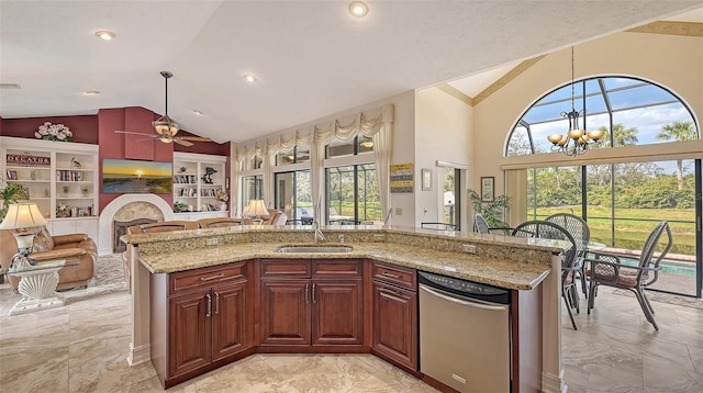 kitchen with open floor plan, a healthy amount of sunlight, a sink, and pendant lighting