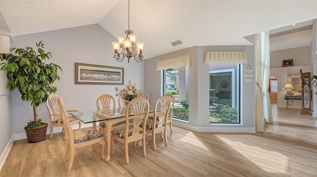 dining room featuring lofted ceiling, a chandelier, visible vents, baseboards, and light wood-type flooring