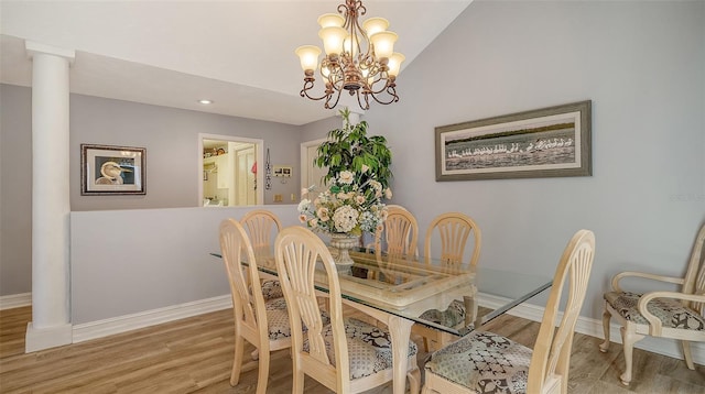 dining area featuring a chandelier, wood finished floors, and baseboards