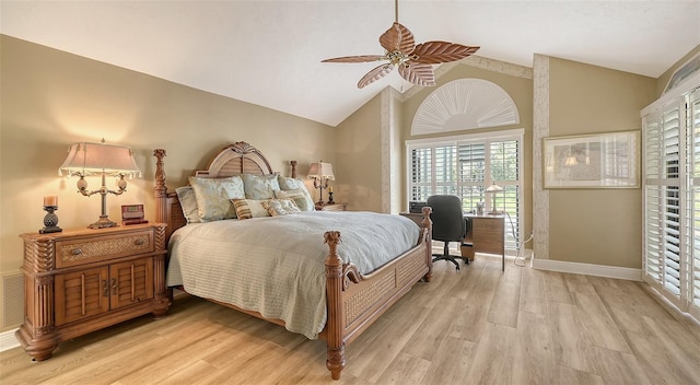 bedroom with light wood-type flooring, ceiling fan, baseboards, and vaulted ceiling