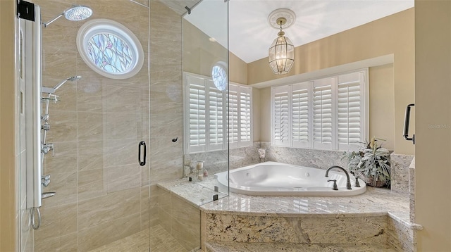 bathroom featuring a stall shower and a bath