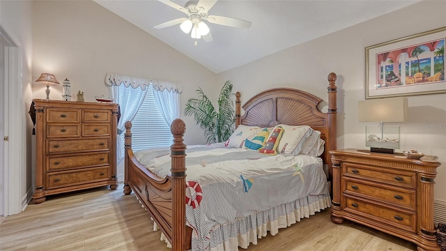 bedroom with light wood-type flooring, ceiling fan, and lofted ceiling