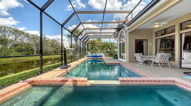 view of pool with a patio area, a water view, ceiling fan, and a lanai