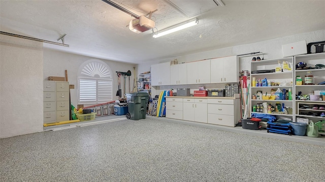 garage featuring a textured wall and a garage door opener