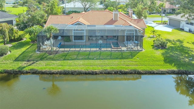 rear view of property featuring a patio area, a water view, a tile roof, and a lanai