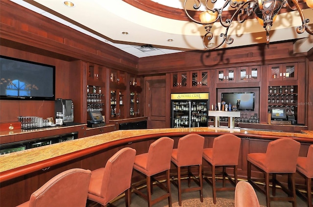 bar featuring a community bar, wine cooler, and freestanding refrigerator