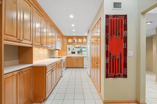 kitchen with light tile patterned flooring and white appliances