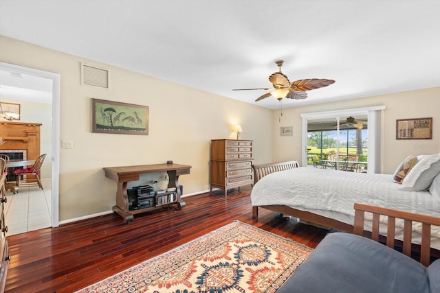 bedroom featuring dark wood-type flooring, access to outside, and ceiling fan