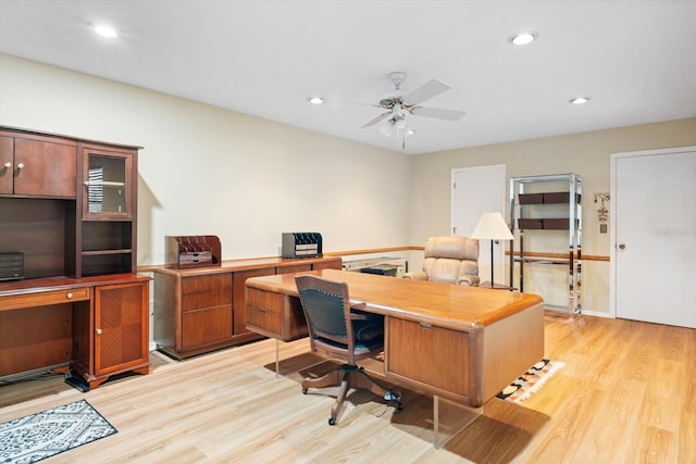 home office featuring ceiling fan and light hardwood / wood-style flooring