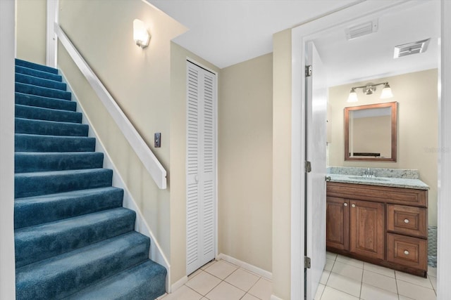 staircase with sink and tile patterned floors