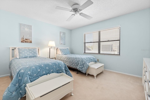 carpeted bedroom with ceiling fan and a textured ceiling