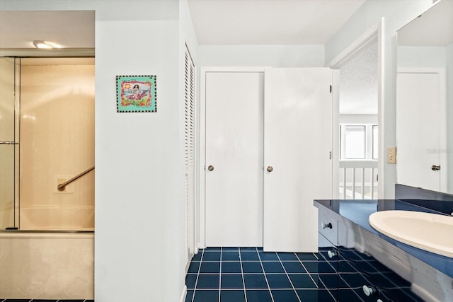 bathroom featuring tile patterned flooring and vanity