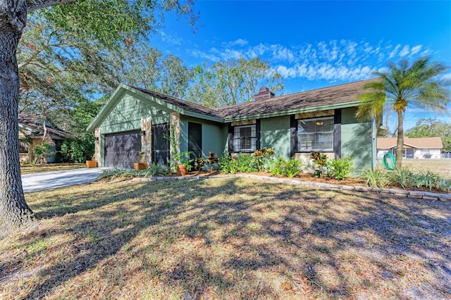 ranch-style home with a garage and a front yard