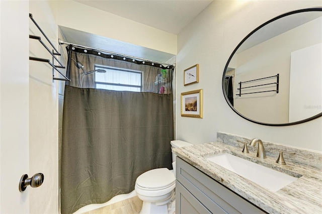 bathroom with vanity, toilet, and curtained shower