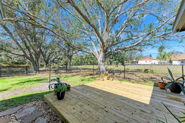 wooden terrace with a yard