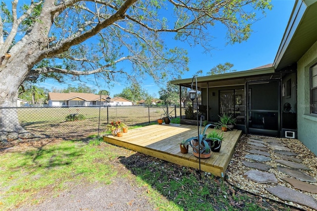 view of yard featuring a sunroom and a deck