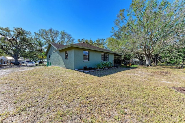 view of side of home featuring a yard