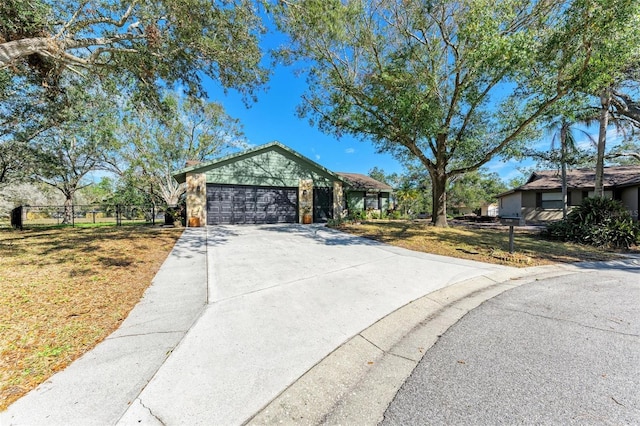 ranch-style home with a garage and a front lawn