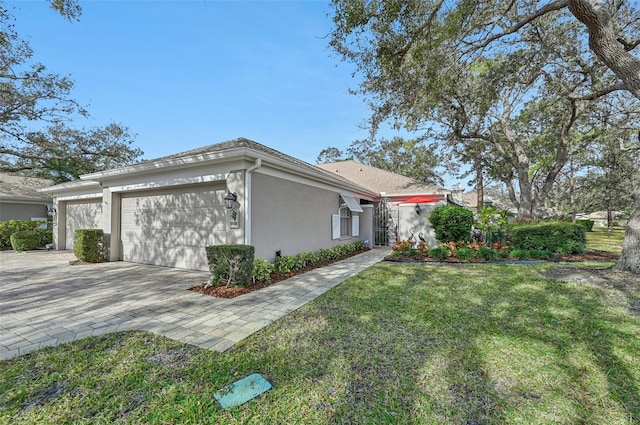 view of property exterior featuring a garage and a lawn