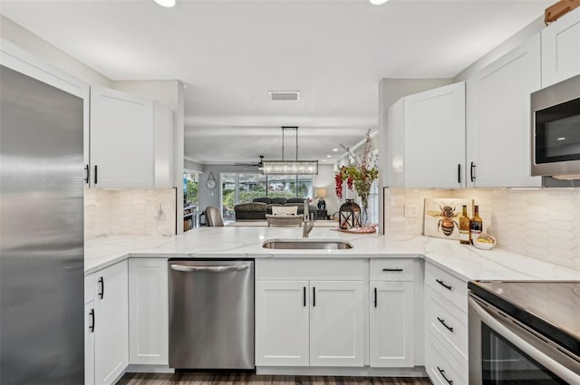 kitchen featuring white cabinetry, stainless steel appliances, and kitchen peninsula