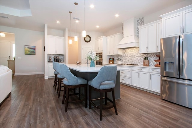 kitchen featuring white cabinetry, decorative light fixtures, and appliances with stainless steel finishes