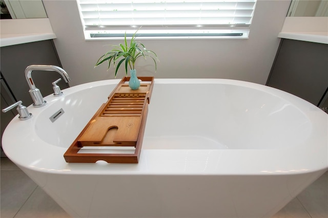 bathroom with tile patterned floors, vanity, and a tub