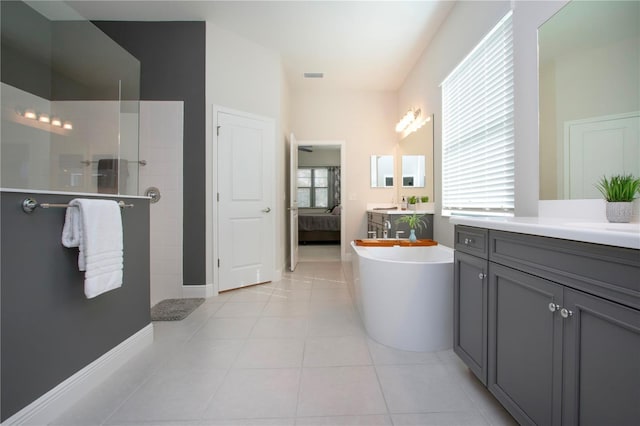 bathroom with tile patterned flooring, vanity, and separate shower and tub