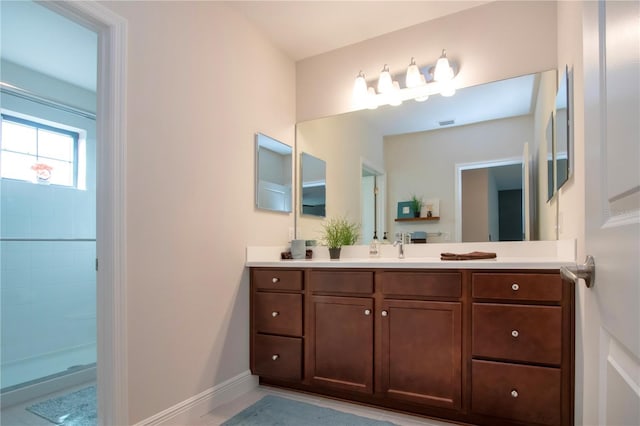 bathroom featuring walk in shower and vanity