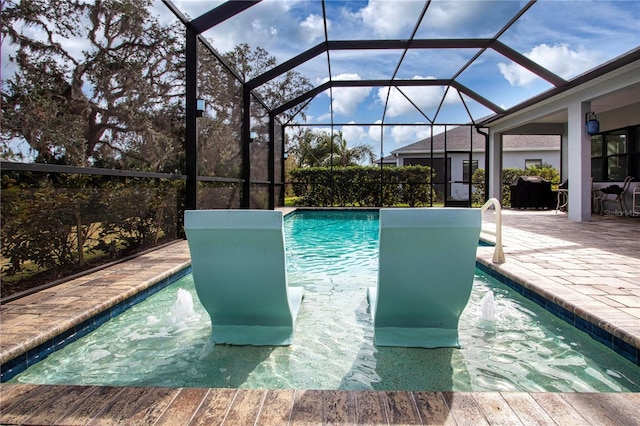 view of swimming pool featuring a patio area and glass enclosure