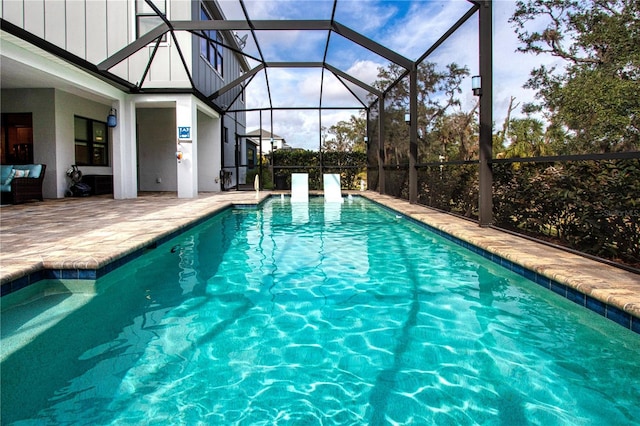 view of swimming pool featuring a lanai and a patio