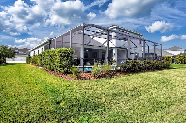 back of house with a yard and glass enclosure