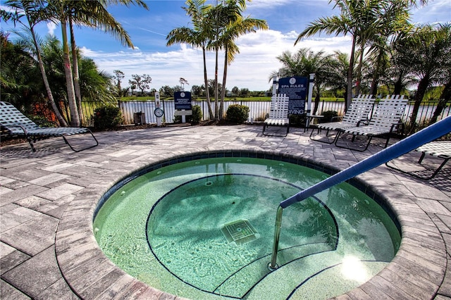 view of pool featuring a hot tub and a patio